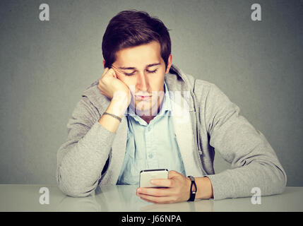 Bored man using his smart phone Stock Photo