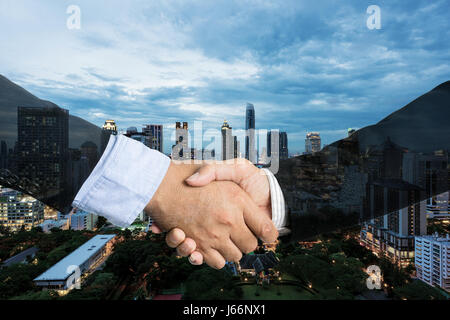Deal or agreement business concept, handshake double exposure, cooperation or partnership business. Stock Photo
