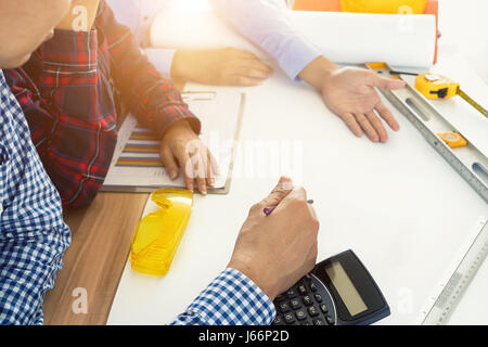 Image of engineer meeting for architectural project. working with partner and engineering tools on workplace. Engineer, discussing, architect concept. Stock Photo