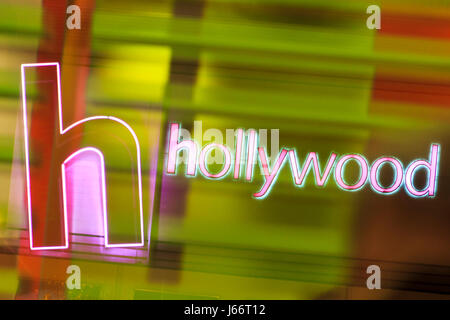 Pink neon Hollywood sign reflected in a green-lit glass window Stock Photo