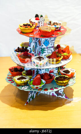 Home-made fancy cakes on a display stand Stock Photo