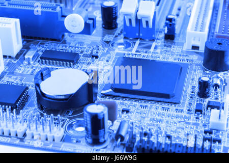 Integrated semiconductor microchip microprocessor on blue circuit board representative of the high tech industry and computer science toned. Stock Photo