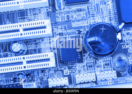 Integrated semiconductor microchip microprocessor on blue circuit board representative of the high tech industry and computer science toned. Stock Photo