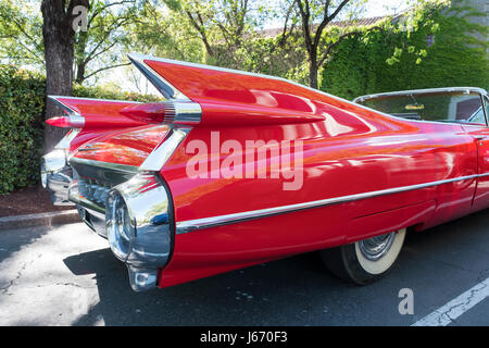 Detail photograph of the tail fins on a vintage red Cadillac convertible, circa 1950's in a car park in Napa county California. Stock Photo