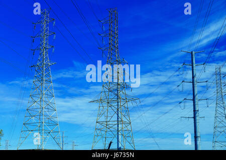 electricity post against blue sky with cloud, chaotic wire with nest on pole electric pole with wires against the sky clouds Stock Photo