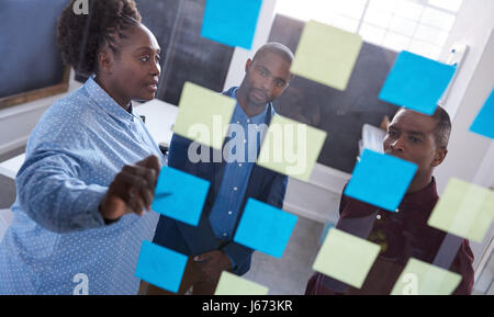 Focused African coworkers brainstorming together in an office Stock Photo