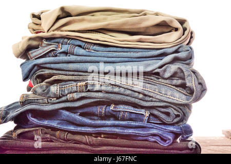 stack of blue jeans on white background Stock Photo