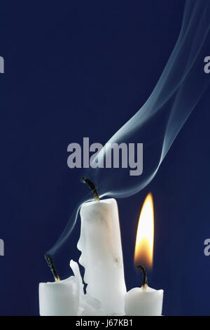 Three Candles, two just out, one still burning Stock Photo