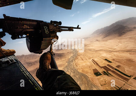 Door Gunners view from the rear of a Bell Boeing V-22 Osprey as it flys to a US Marine Base in Nowzad,  Helmand Province, Afghanistan Stock Photo
