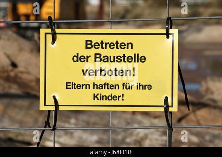 yellow warning sign at German construction site Stock Photo