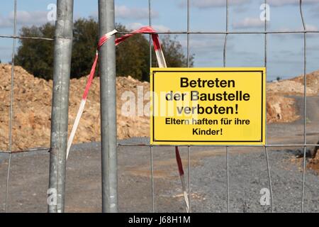 yellow warning sign at German construction site Stock Photo