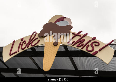 Napier, New Zealand - March 9, 2017: Lick this slogan on billboard with ice cream cone under silver sky and fixed on a roof.