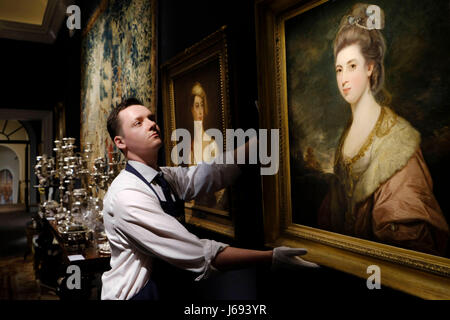 London, Belgravia home of Lord Ballyedmond presented in the Sotheby's auction house sale which recalls the aristocratic London town house in London. 19th May, 2017. A Sotheby's staff member adjusts a painting titled Portrait of Mrs Richard-Pennant by artist Sir Joshua Reynolds, from the Belgravia home of Lord Ballyedmond presented in the Sotheby's auction house sale which recalls the aristocratic London town house in London, Britain on May 19, 2017. Credit: Ray Tang/Xinhua/Alamy Live News Stock Photo