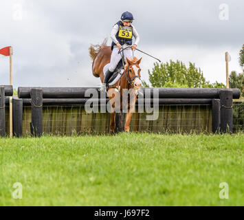 Rockingham Castle grounds, Corby, England. Saturday 20th May 2017. Boo Guest and her horse Nanteglwys Brynmor leap an obstacle in the cross country phase of the Rockingham International Horse Trials on Saturday 20th May 2017 in the grounds of the norman Rockingham castle at Corby, England. Credit: miscellany/Alamy Live News Stock Photo