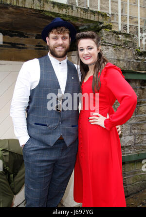 Haworth, UK. 20th May, 2017. A couple in period dress enjoying Haworth 1940s weekend, despite the rain. Photo: Paul Thompson Credit: West Yorkshire Images/Alamy Live News Stock Photo