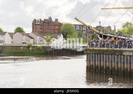 Glasgow, Scotland, UK. 20th May, 2017. UK weather - bright sunshine, dark clouds and showers at the Riverside Museum in Glasgow for the Scottish Boat Race 2017. The battle between Edinburgh and Glasgow University Boat Clubs is in its 140th year. Edinburgh womens team seen here celebrating Credit: Kay Roxby/Alamy Live News Stock Photo