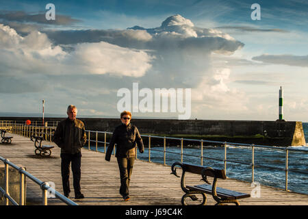 Aberystwyth Wales Uk, Saturday 20 May 2017  UK Weather: People walking along Aberystwyth promenade in the evening as dramatic storm clouds gather behind them over Cardigan Bay on the west Wales coast  photo credit Keith Morris / Alamy Live News Stock Photo