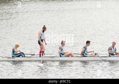 Glasgow, Scotland, UK - 20th May 2017: UK weather - bright sunshine, daark clouds and showers at the Riverside Museum in Glasgow for the Scottish Boat Race 2017.  The battke betweeb Edinburgh and Glasgow University Boat Clubs is in its 140th year.  Edinburgh mens team seen here celebrating a convincing victory on the River Clyde Stock Photo