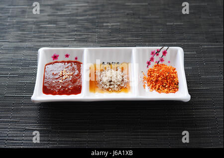 Three style of sauce in white platter in korean restaurant Stock Photo