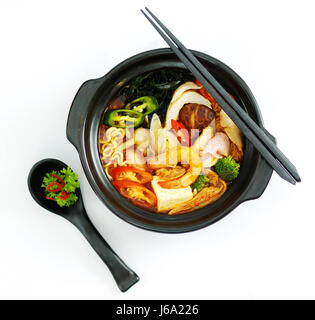 Hot chili ramen noodle with seafood in black stew Stock Photo