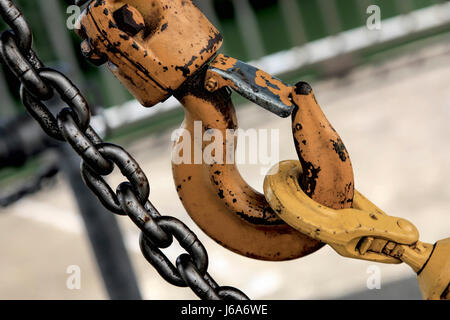 Steel chain and large yellow old industrial hook Stock Photo