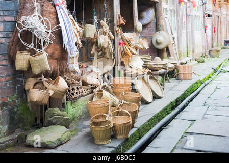 Hongya, Sichuan Province, China - Apr 29, 2017: Multiple straw objects in a small shop in an ancient village Stock Photo