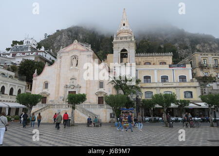 Nice church in Taormina, Sicily island, Italy.On a square, interesting design and facade. Misty weather, in fof, hill on backgrounds Stock Photo