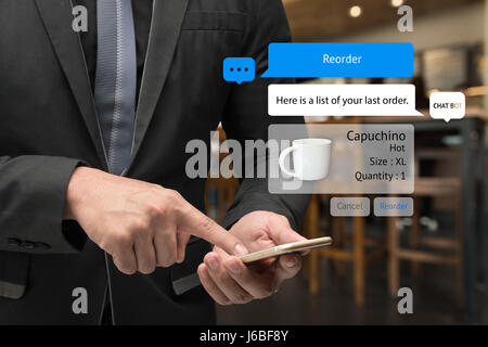 Chatbot future marketing and car sharing concept. Business man suit using smart phone and chat bot graphic icons with coffee shop background. Stock Photo