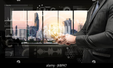 Business man suit using smart phone and Technology graphic with widow metropolis city background. Chatbot , Smart city and internet of things concept. Stock Photo