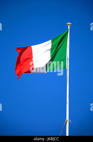 Italian Flag against a blue sky on top of the main guard building in St Georges Square, Valletta, Malta, Europe. Stock Photo