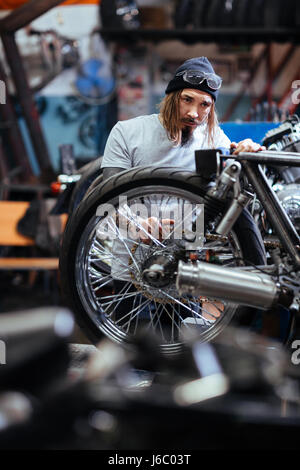Young repairman or technician working in garage Stock Photo