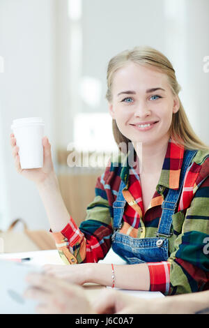 Pretty girl with drink looking at camera Stock Photo