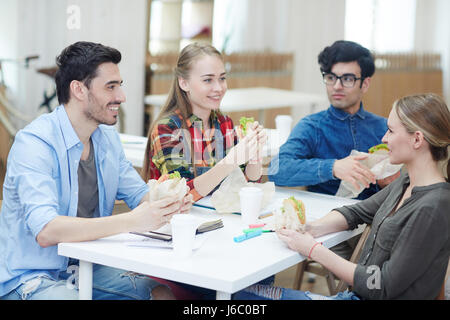 Friendly students having snack at break Stock Photo