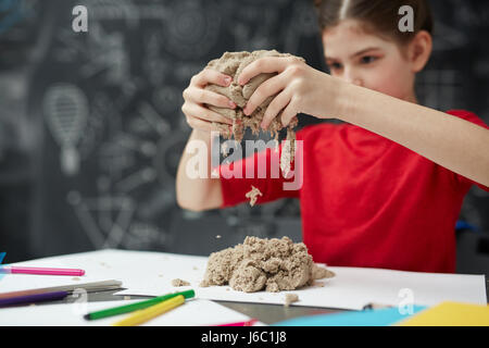 Little Hands Playing Kinetic Sand Molds Red Tra Stock Photo by