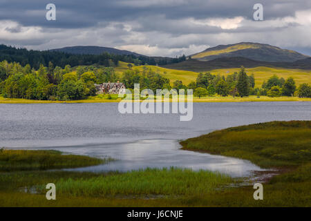 House on scottish lake after a thunderstorm,. Typical scottish landscape, Scotland, United Kingdom Stock Photo