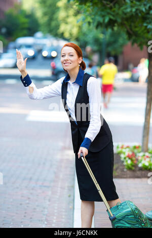 Portrait pretty young business woman with travel bag, luggage, hails taxi cab in the city, Washington DC isolated street background. Positive human em Stock Photo