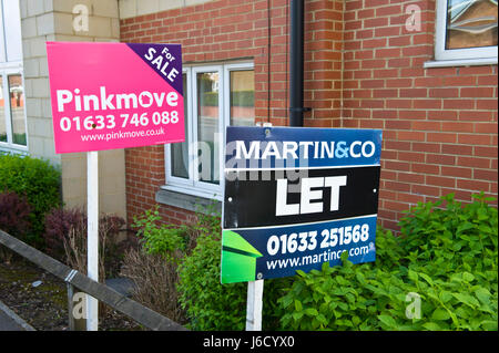 Estate agents for sale sign outside properties in Newport, South Wales, UK Stock Photo