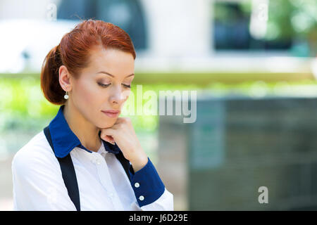 Closeup portrait, headshot day dreaming, thoughtful pretty, attractive, stylish business woman posing outdoors on urban Washington DC street backgroun Stock Photo