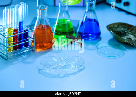 Glasses and scientific experiments in laboratory Stock Photo