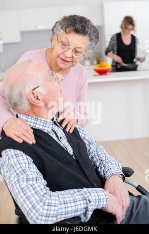 Elderly woman embracing her husband Stock Photo