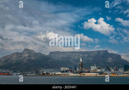Table Mountain outline with Cape Town port on horizon with dramatic cloud formations in the sky, South Africa Stock Photo