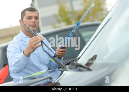 Man fitting new windcreen wiper blade Stock Photo