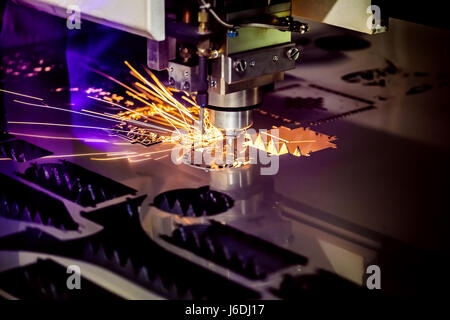 CNC Laser cutting of metal, modern industrial technology. Small depth of field. Warning - authentic shooting in challenging conditions. A little bit g Stock Photo