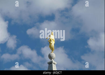 Blue sky white clouds view back of golden Angel Moroni Statue, Salt Lake Temple, from north-west side Temple Square, Salt Lake City, Utah, USA Stock Photo