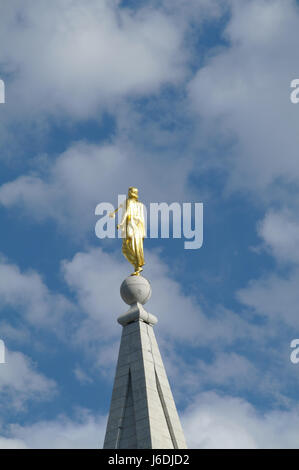 Blue sky white clouds portrait back golden Angel Moroni Statue, Salt Lake Temple, from the north-west side of Temple Square, Salt Lake City, Utah, USA Stock Photo