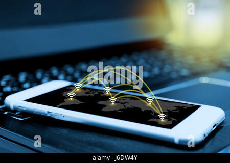 Wifi icon and network connection concept and smartphone screen with blur laptop background , wireless communication network , internet of things , fla Stock Photo