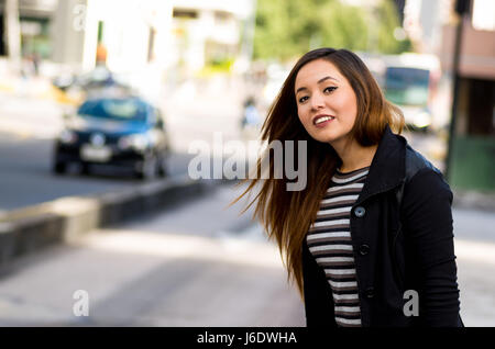 Beautiful young woman on the street in the city with air pollution, city background Stock Photo