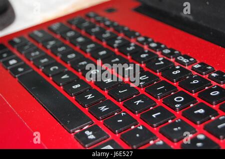 Laptop keyboard cropped image black on red Stock Photo