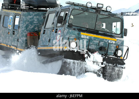 An M973A1 Small Unit Support Vehicle , aka SUSV, clad in emergency lights and digital camouflage, claws its way through the snow at Taylor Park Reservoir near Gunnison, Colo., March 15, 2010. The SUSV, which is capable of traversing almost any terrain, is the primary vehicle used by the Colorado Army National Guard’s Snow Response Team. This relatively unknown asset can be used by the SRT to assist state and local rescue teams during nearly every type of disaster, state emergency or search and rescue. (U.S. Army National Guard photo by Spc. Joseph K. VonNida, Colorado National Guard) Stock Photo