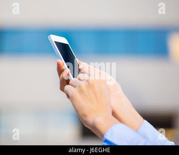 Closeup young female hands using, holding smart phone isolated on city background. Digital technology, new generation gadget device, connection, commu Stock Photo